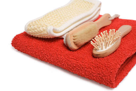 Bast, brush and hairbrush on a red terry towelの写真素材