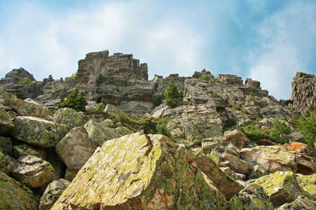 Top of rock against blue sky.の写真素材