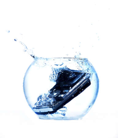 Black mobile phone thrown in aquarium.の写真素材