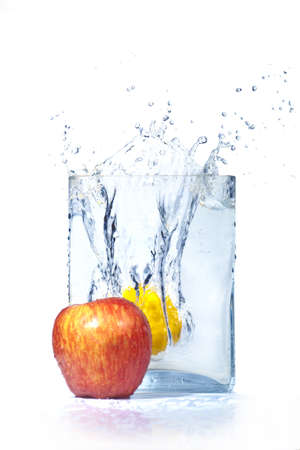  apple and lemon in water and splashes is isolatedの写真素材