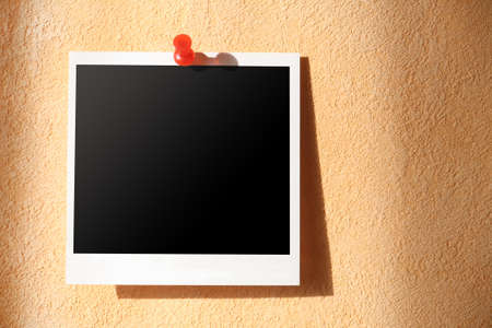 Square photo attached on  rough wall