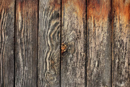 Wooden fence hammered together from rough pine boardsの写真素材