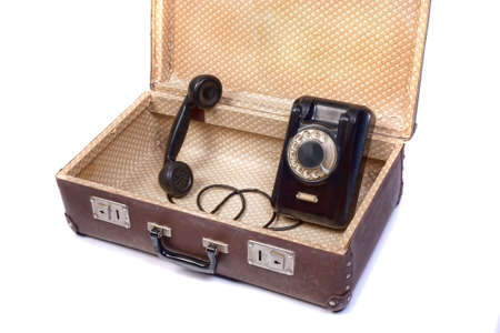 Old rotational phone in old suitcaseの写真素材