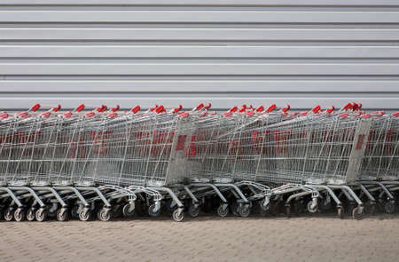 number of metal carts at supermarket wallの写真素材