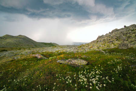 Mountain landscape with the cloudy sky and  rainの写真素材