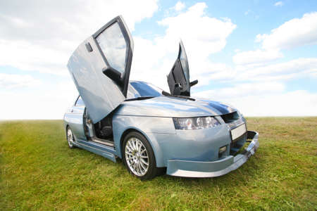 Sports car in the field against the skyの写真素材