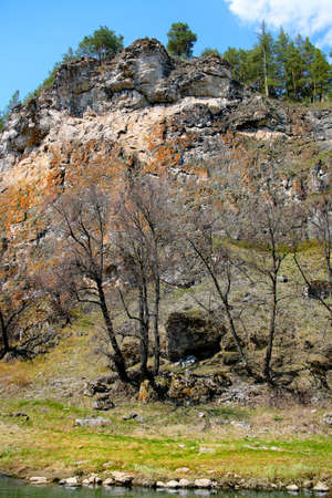 High rock on river bank in the springの写真素材