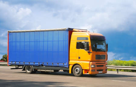 big auto truck goes on the way to sky backgroundの写真素材