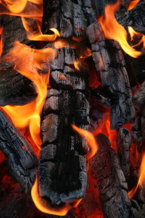 Bright flame burning outside of fire woodの写真素材