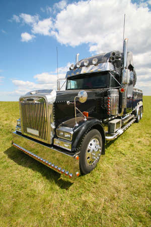 big black brilliant American truck in fieldの写真素材