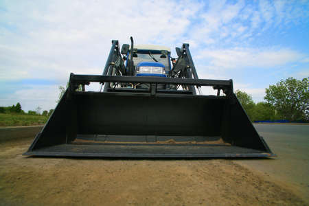 loader with black ladle on the roadの写真素材