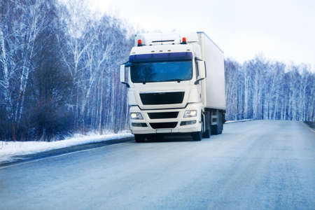 big trailer goes on the winter roadの写真素材