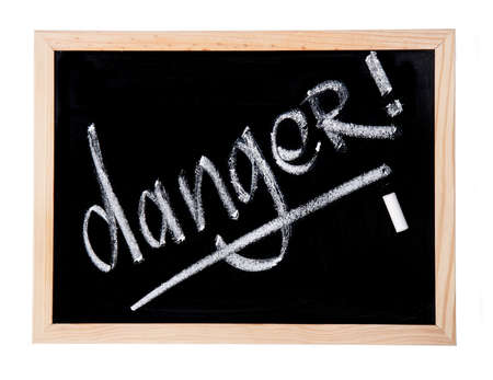 word danger written by chalk on blackboardの写真素材