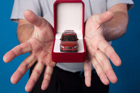 open box with car in mans hands