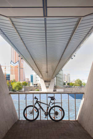 bicycle parked under bridge footings against the business center