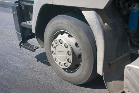 wheel of the truck going on the asphalted highwayの写真素材