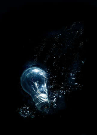 bulb in water with bubbles on black backgroundの写真素材