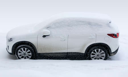 white car the SUV under snow in the winterの写真素材