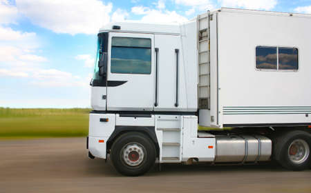 big white truck goes on the country roadの写真素材
