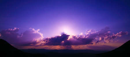 beautiful sunrise behind clouds over plateauの写真素材