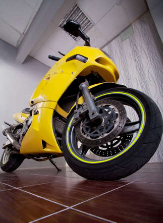 big yellow powerful motorcycle in garageの写真素材
