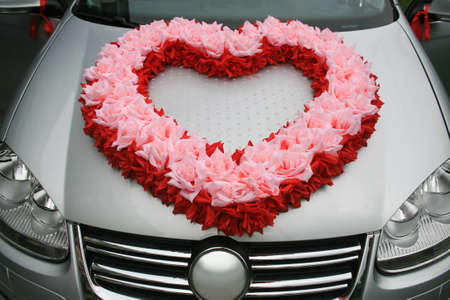wedding car with heart from flowers on cowlの写真素材
