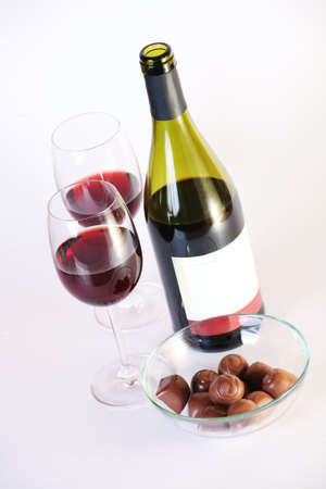 wine glasses chocolate bottle of red wine on white backgroundの写真素材