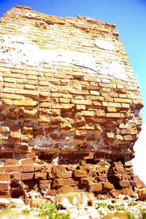 old destroyed brick wall against the sky