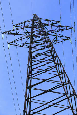 high voltage line support against the blue sky
