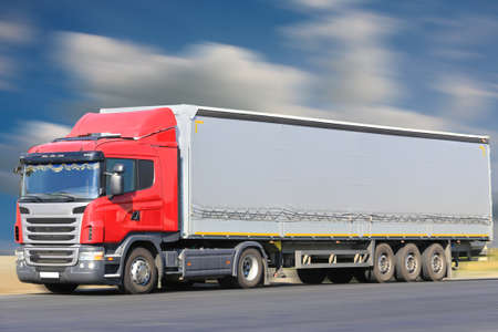 big red truck goes on the highwayの写真素材
