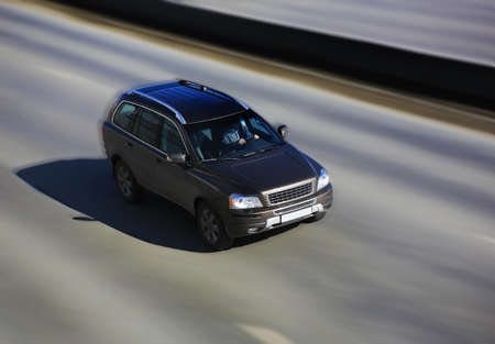 SUV rushes on the wide highway in the afternoonの写真素材