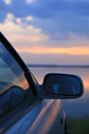 car on the river bank against the evening skyの写真素材