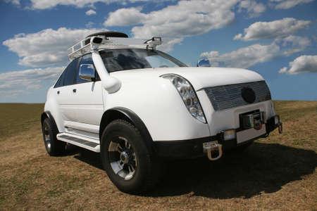 big white off-road car in the fieldの写真素材