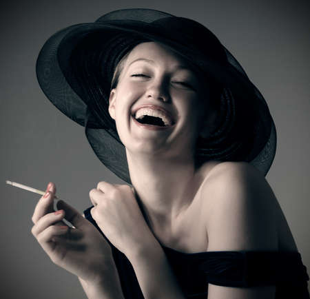 portrait of the beautiful laughing girl in hat