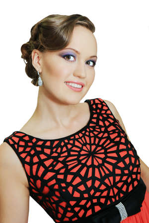 beautiful girl in red dress poses in studioの写真素材