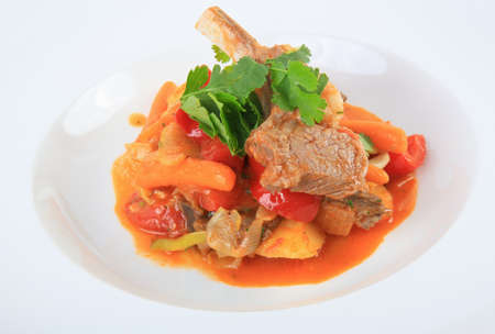 meat welded with vegetables on white plateの写真素材