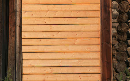 wall from pine boards between wooden houses