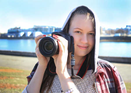 beautiful girl the photographer photographs in the cityの写真素材