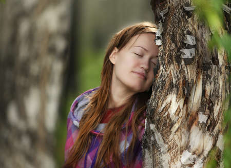 beautiful girl dreams in the wood near birchの写真素材