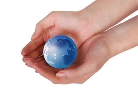 blue glass globe in female handsの写真素材