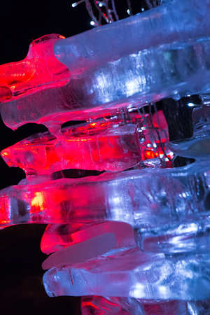 pieces of ice illuminated by color garlandsの写真素材