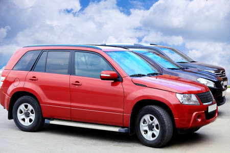 three SUVs on asphalt against the sky