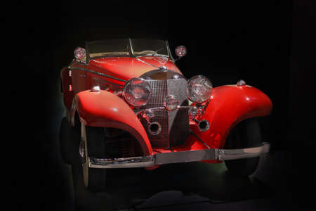red beautiful ancient car on black backgroundのeditorial素材