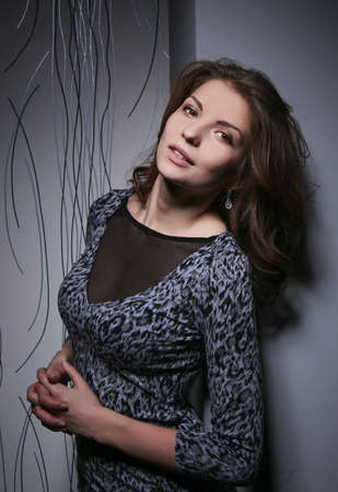 beautiful girl the brunette near a wallの写真素材