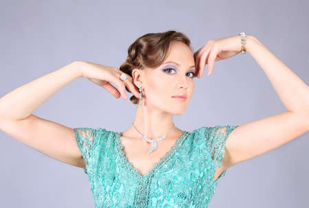portrait of the beautiful girl with make-up in green dressの写真素材