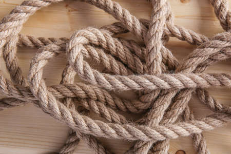 thick hempen rope on wooden boardの写真素材