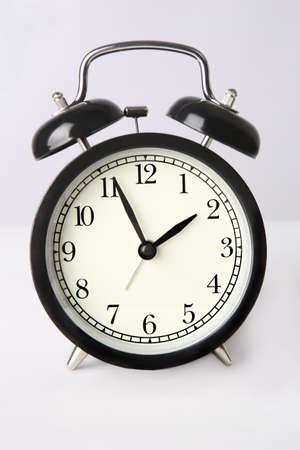 round black mechanical clock on white backgroundの写真素材