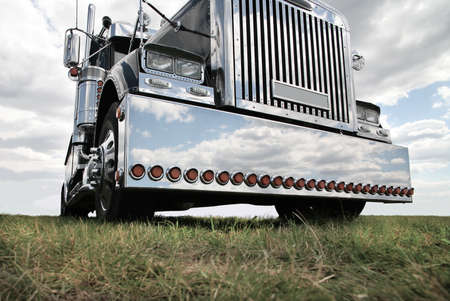 big black brilliant American truck in fieldの写真素材