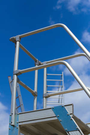 metal aluminum step-ladder against the skyの写真素材