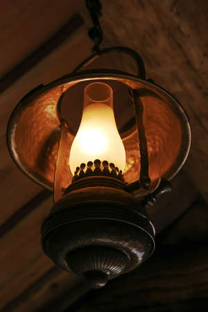 ancient kerosene metal lamp indoorsの写真素材